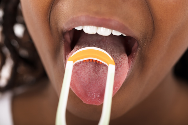 How To Use A Tongue Scraper