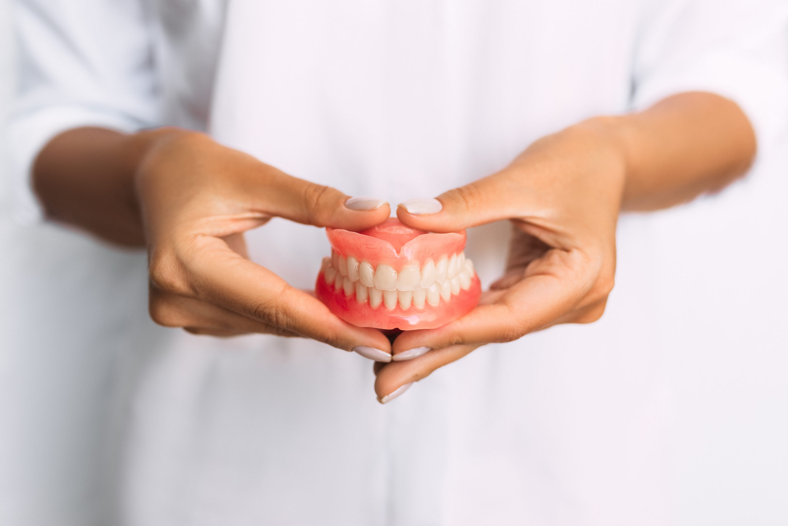 Dentures in patient's hands